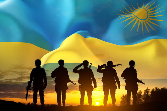 Silhouettes of soldiers against the sunset with Rwanda flag. National Holidays concept