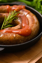 Close-up of grilled sausage with sauce.