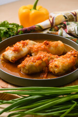 Close-up of stuffed cabbage rolls in tomato sauce.