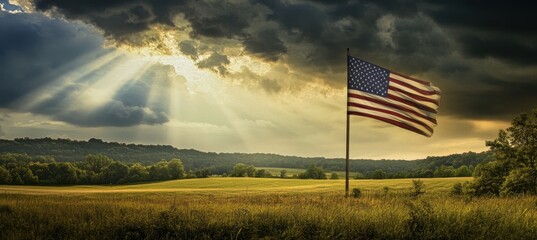 A digital art collage of the American flag waving in an idyllic countryside landscape, with rays of sunlight breaking through dark clouds above Generative AI