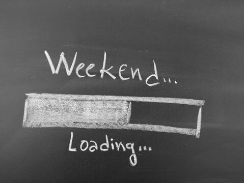 Handwritten chalkboard text of 'weekend loading' with a progress bar illustration conveying anticipation and upcoming relaxation