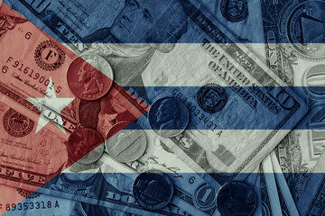 colourful flag of cuba on a dollar money banknotes and coins background. finance concept. macro shot