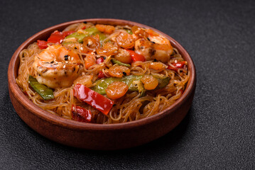 Glass noodles with shrimps and seafood, vegetables, spices and soy sauce