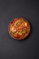 Glass noodles with shrimps and seafood, vegetables, spices and soy sauce