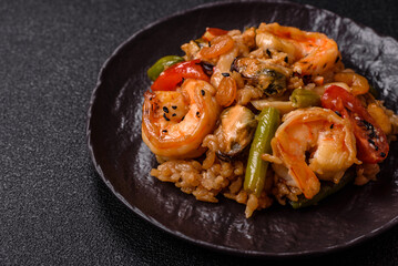 Rice with shrimps and seafood, vegetables, spices and soy sauce