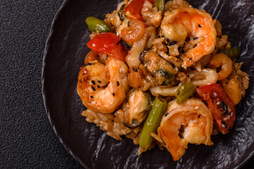 Rice with shrimps and seafood, vegetables, spices and soy sauce