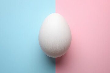 Egg on Split Pastel Background: Minimalist Art with Blue and Pink Contrast