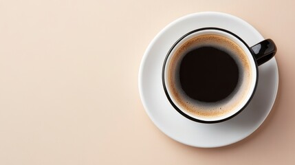 A simple black coffee cup on a white saucer, sitting against a soft beige background, inviting warmth and comfort.