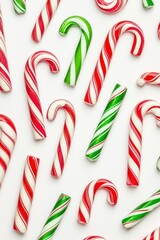 Fototapeta premium Red and green candy canes scattered on a white background
