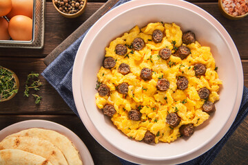 Delicious scrambled eggs with spiced Middle Eastern sausage or ''Sujuk''. Top view with close up.