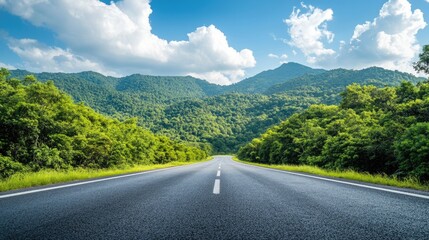 Empty Road Winding Through Lush Green Mountain Landscape