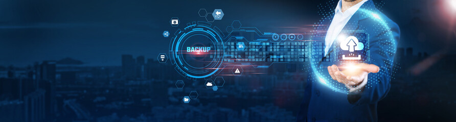 Backup: Businessman holding icon and data exchanges representing secure connection on city background, disaster recovery, cloud storage, data integrity, and system security.