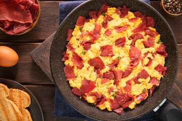 Delicious scrambled eggs with crispy pastrami is an iconic Armenian-Egyptian dish for breakfast or brunch.
