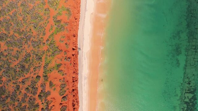 Aerial view of pristine beach with turquoise water and red earth, Bottle Bay, Francois Peron National Park, Australia.