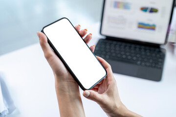A person is holding a cell phone with a white screen