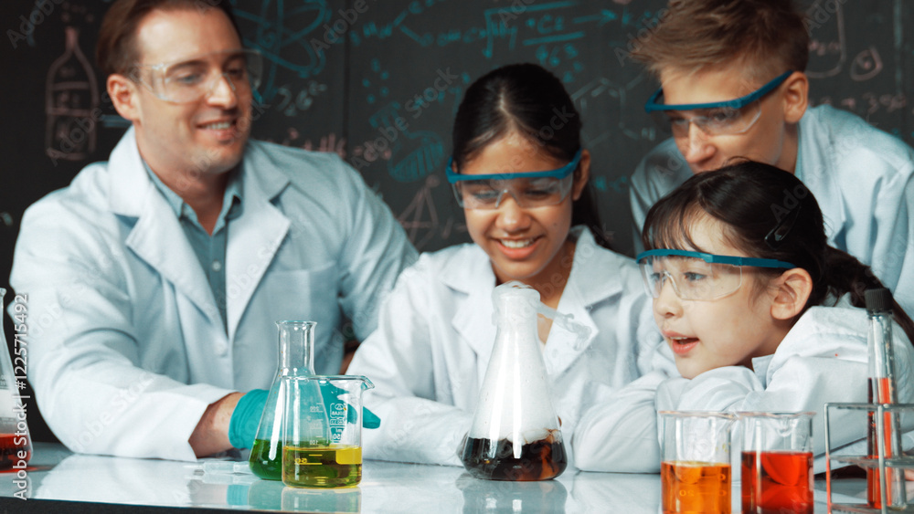 Poster girl looking at beaker while doing experiment at blackboard with chemistry theory in stem class. tea