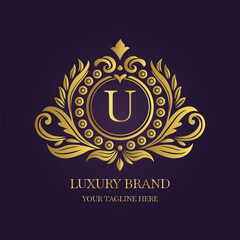 Gold Letter 'U' Logo with Ornamental Patterns and Floral Motifs on Purple  
