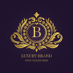 Gold Letter 'B' Logo with Ornamental Patterns and Floral Motifs on Purple  
