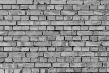 Black and white picture of an old brick house wall