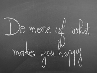Handwritten inspirational quote on chalkboard background emphasizing the pursuit of happiness and self-fulfillment