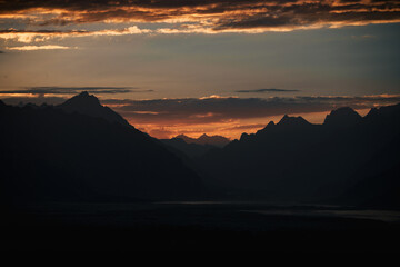 Orange sunset illuminating the peaks of karakorum mountain range in pakistan