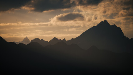 Stunning sunset illuminates the rugged peaks of the karakorum range in pakistan, creating a breathtaking natural spectacle