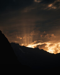 Sun rays filtering through clouds during golden hour in the karakorum mountain range, pakistan