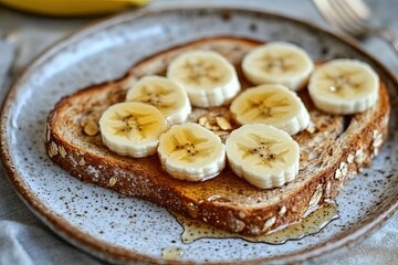 A whole - grain toast with almond butter, sliced bananas, and a drizzle of honey