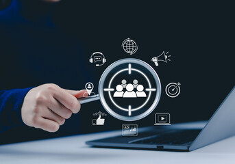 Digital marketing and target audience concept. Magnifying glass over a digital interface with...