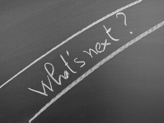 Fototapeta premium Blackboard with handwritten text 'What’s next?' surrounded by underlines, reflecting a thoughtful and introspective theme.
