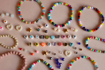 Friendship bracelet spelled with letter beads. Colorful handmade bracelets and various beads....