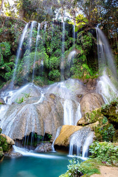 El Nicho Waterfalls in Cuba. El Nicho is located inside the Gran Parque Natural Topes de Collantes a forested park that extends across the Sierra Escambray mountain range in central Cuba.