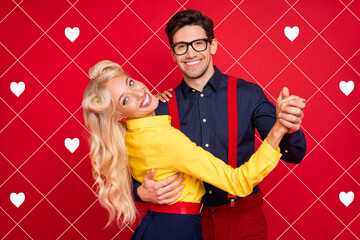 Photo of beautiful sweet young guy lady wear pin up clothes dancing twist smiling isolated red...