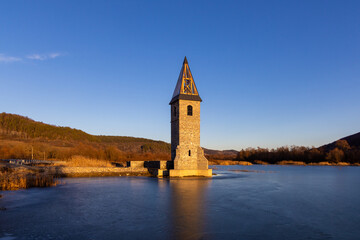 Landscape with the ruins of the flooded church in Lake Bezid - Romania
