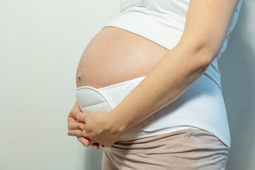 Pregnant woman in the maternity belly band