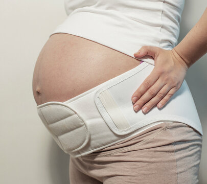 Pregnant woman in the maternity belly band