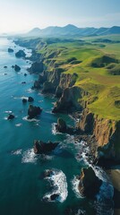 Coastline viewed from above showcasing cliffs and ocean at sunrise in a lush green landscape