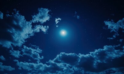Obraz premium A luminous full moon surrounded by a clear starry night sky with soft, scattered clouds creating a serene and tranquil atmosphere