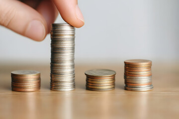 Close-up view of stacked coins on a wooden table, symbolising financial growth, savings, investment, and economic stability