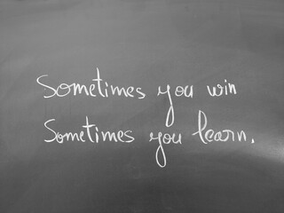 Inspirational chalkboard message featuring the quote 'Sometimes you win, sometimes you learn' in handwritten text