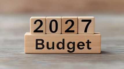 2027 Budget' spelled out on wooden blocks alongside financial elements, symbolising planning, forecasting, and economic strategy for the future