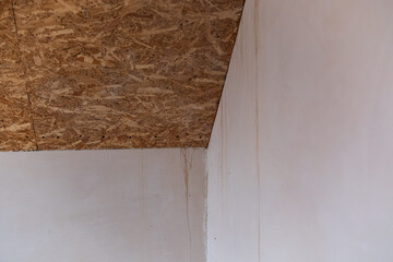 Water damage on wall and ceiling in a residential room during repairs