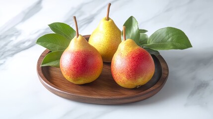 Three whole ripe red yellow pear fruits with green leaves on wooden plate tray closeup isolated on white marble table background Healthy food Fresh Forelle Pear
