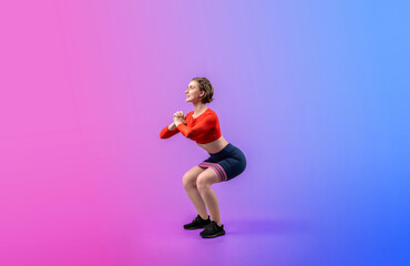 Full body length gaiety shot athletic and sporty young woman with fitness elastic resistance band in squat exercise posture on isolated background. Healthy active and body care lifestyle.