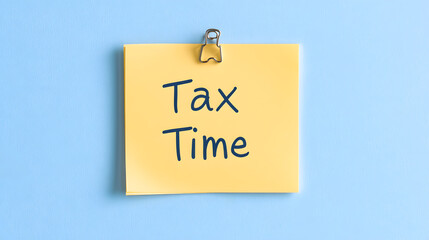 Tax Time Text on Yellow Sticky Note &ndash; Reminder for Tax Filing, Financial Deadlines, Accounting, IRS Payments, Business Taxes, and Personal Finance Planning on a Sticky Note