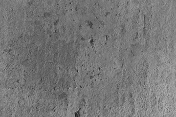 Textured surface showing natural patterns and signs of erosion in a rocky area