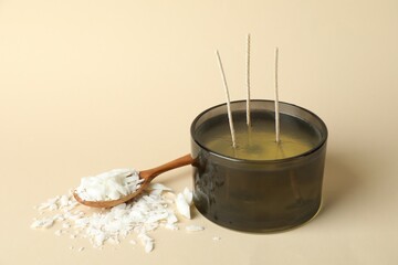 Soy wax, candle and spoon on beige background, space for text