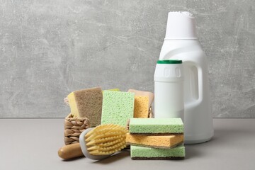 Eco-friendly cleaning products and supplies on grey table