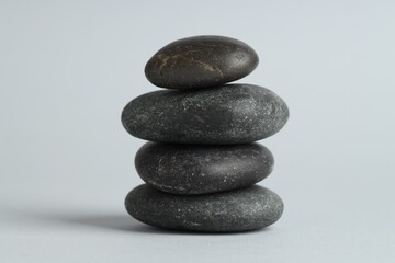Stack of rocks on gray background. Harmony and life balance
