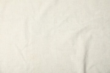 Texture of beige tablecloth as background, top view
